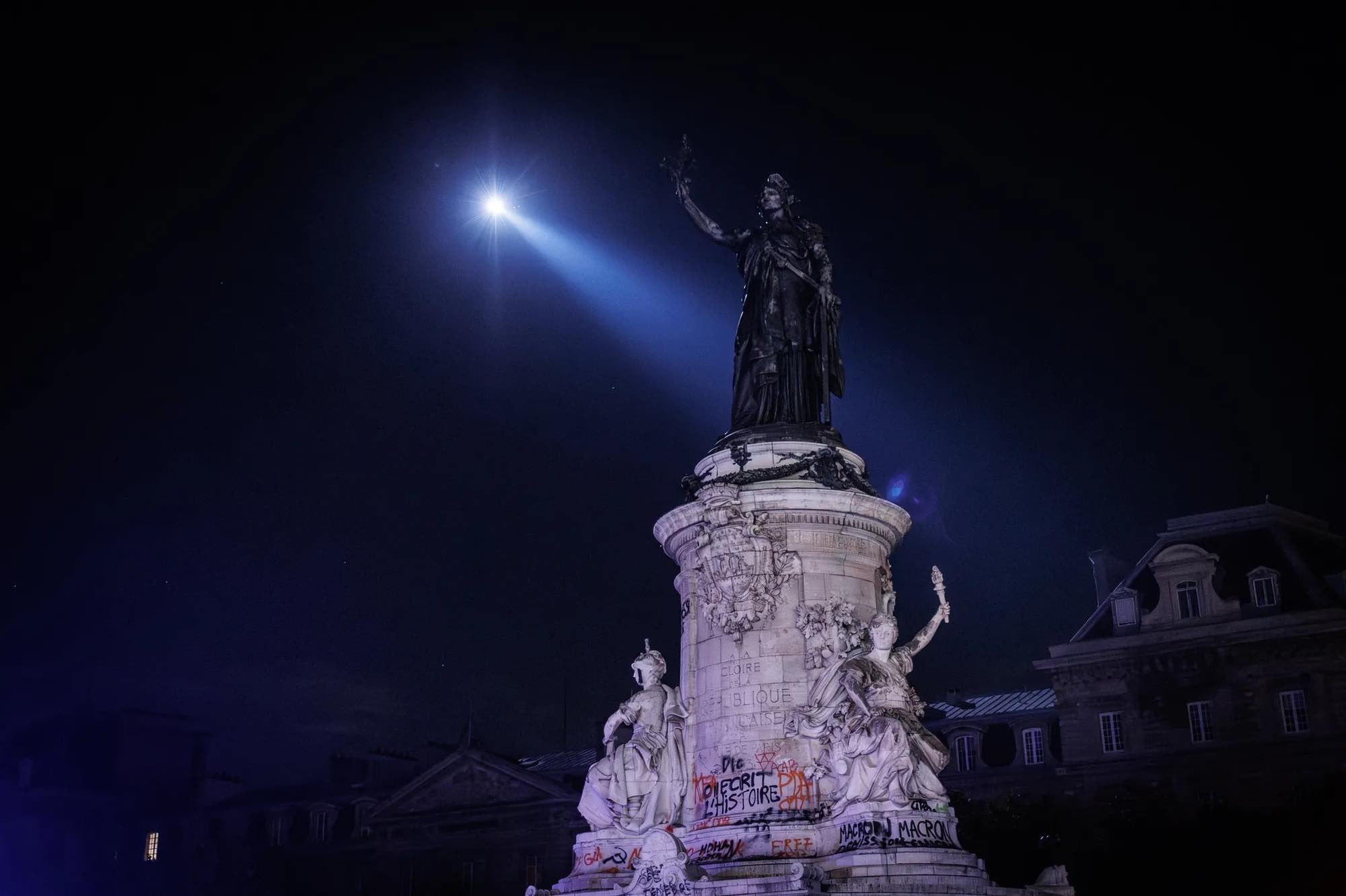 Helicopter hovering over Place de la République during the curfew implemented in Paris.